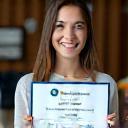 Satisfied LinguaBridge student holding certificate after passing IELTS